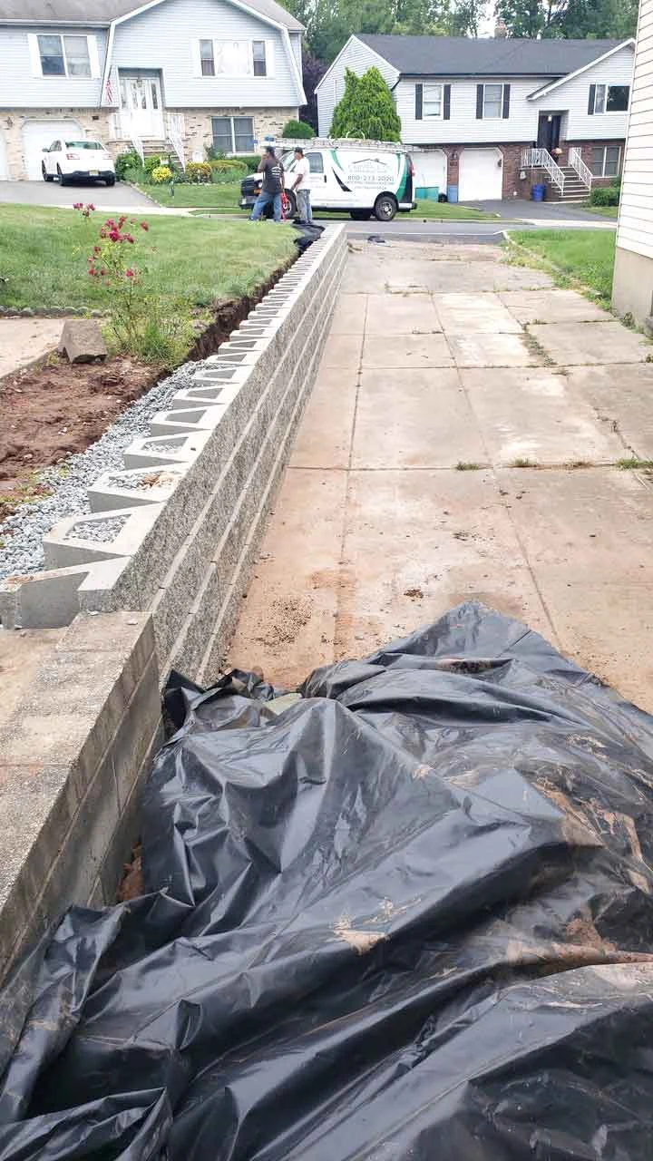 Retaining wall installation in progress from AJT’s masonry project gallery